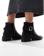 ‌Stylish ankle boots with buckle details in black
